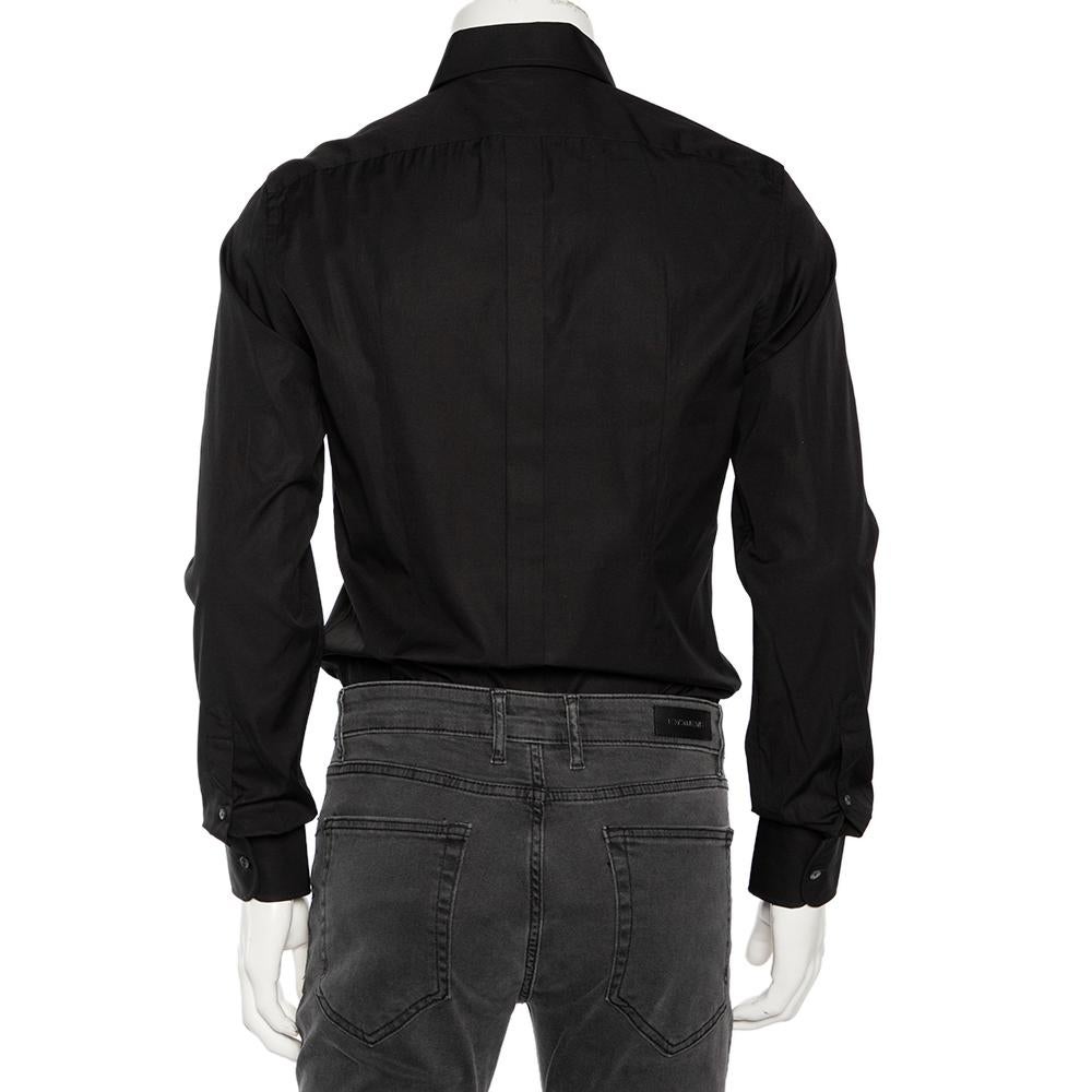 Shirts are an indispensable part of a man's wardrobe, so Dolce & Gabbana brings you a creation that is both versatile and stylish. It has been tailored from cotton in a black shade. The shirt is detailed with front buttons, a classic collar, and