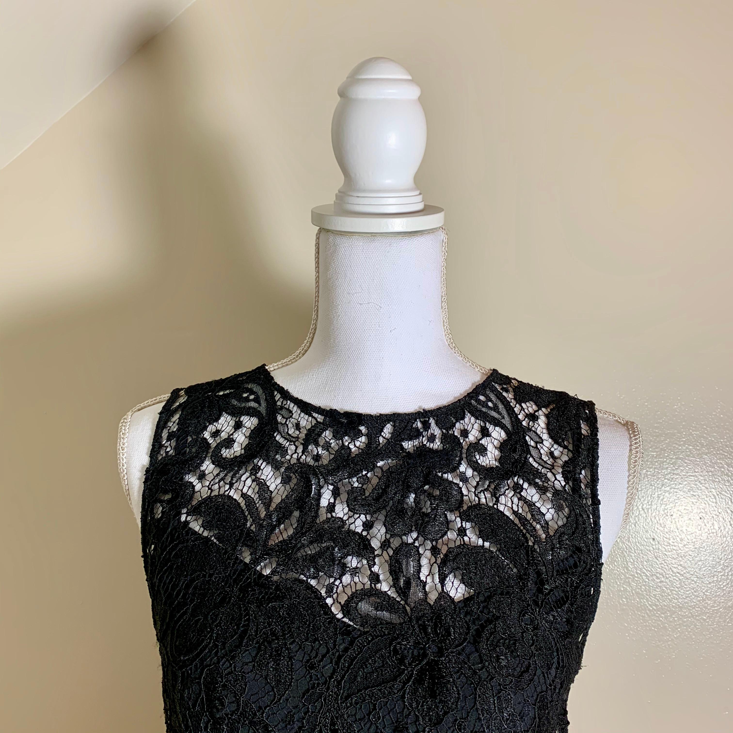 From Dolce & Gabbana, a self-lined black lace sleeveless dress. An iconic D&G design with variations seen in every one of their collections.

Beautiful Italian cotton lace in black, over a silk slip lining. Both the slip and the lace shell have