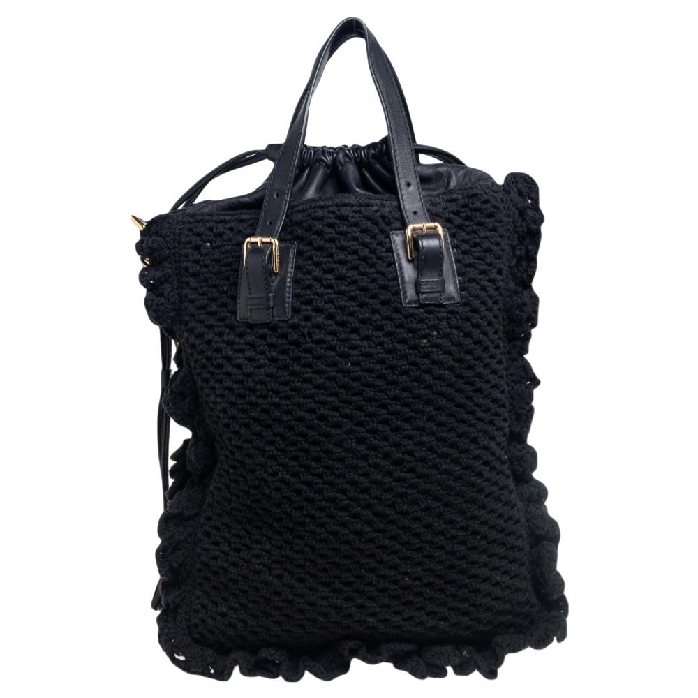 This beautifully stitched Miss Helen tote in crochet fabric and leather is by Dolce & Gabbana. With a capacious lined interior, it will house more than your essentials. Boasting two handles, metal chains, and a fine finish, this tote offers style