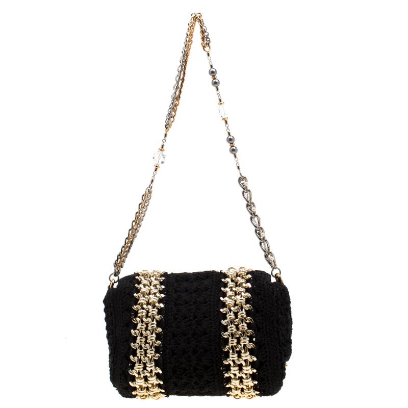 This bag will give one a feeling of being chic and in fashion. Featuring a stylish design, this bag comes in a crochet fabric body with gold-tone metal chain detailing. This unique bag by Dolce & Gabbana, equipped with a fabric interior and a chain