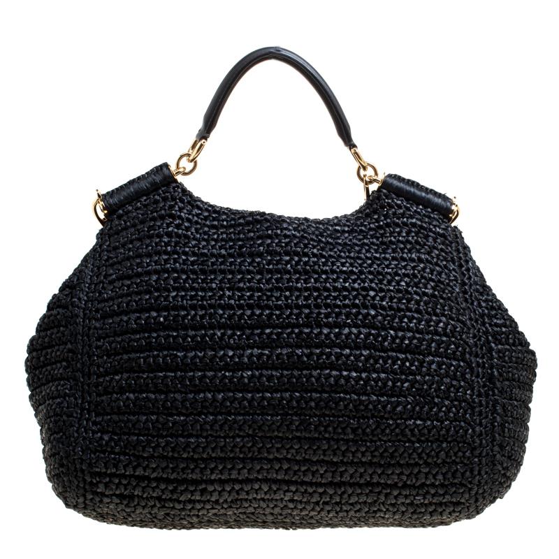 Miss Sicily tote from Dolce and Gabbana is truly a masterpiece. The crochet straw bag features a top handle, a detachable shoulder strap and an adorable removable pouch. The front flap features bead detailing and opens to a leopard print fabric