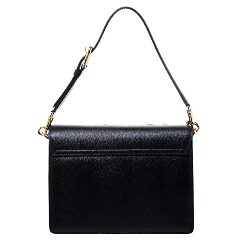 Shoulder bags as pretty as this one by Dolce & Gabbana are not creations you find every day. That's why this bag is worthy of a place in your closet. It has been crafted from leather in black and styled with a flip-lock on the flap to secure the