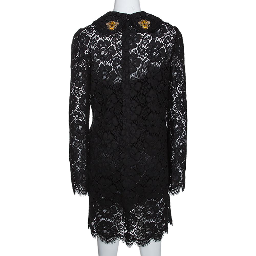 Dolce & Gabbana brings you this beautiful dress designed with a luscious spread of black floeal lace and accompanied by a smart shift silhouette with gold-tone buttons to the front, long sleeves and bee appliques on the front and back collar. A pair