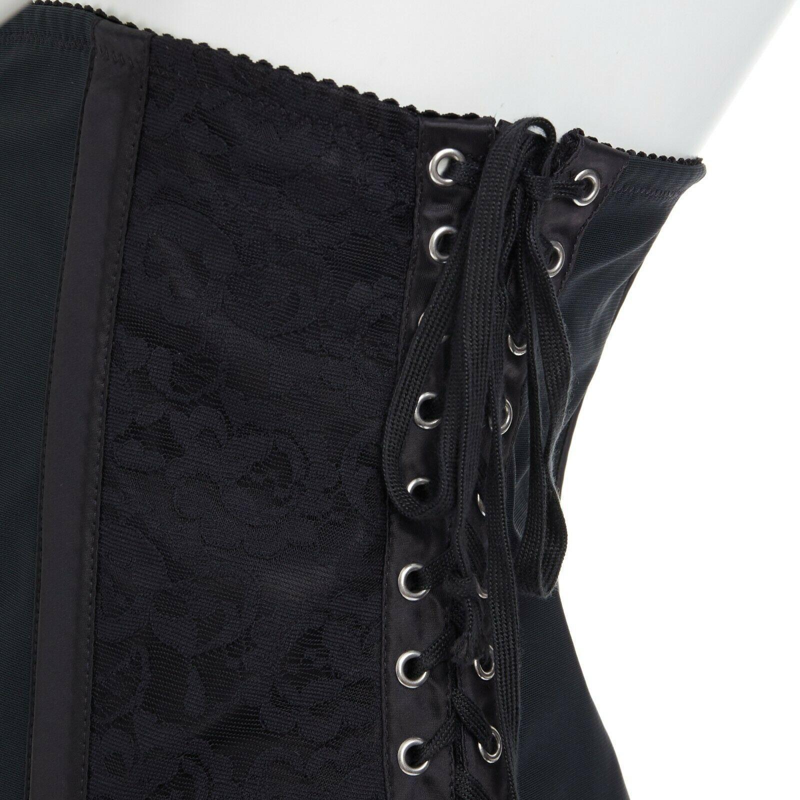 DOLCE GABBANA black floral lace boned laced up corset belt IT42 M
DOLCE & GABBANA
Black floral lace and mesh panel. Boned satin trimming. Velvet trimming. 
Hook and eye closure. Adjustable corset lace detail. Scalloped edges. 
Made in