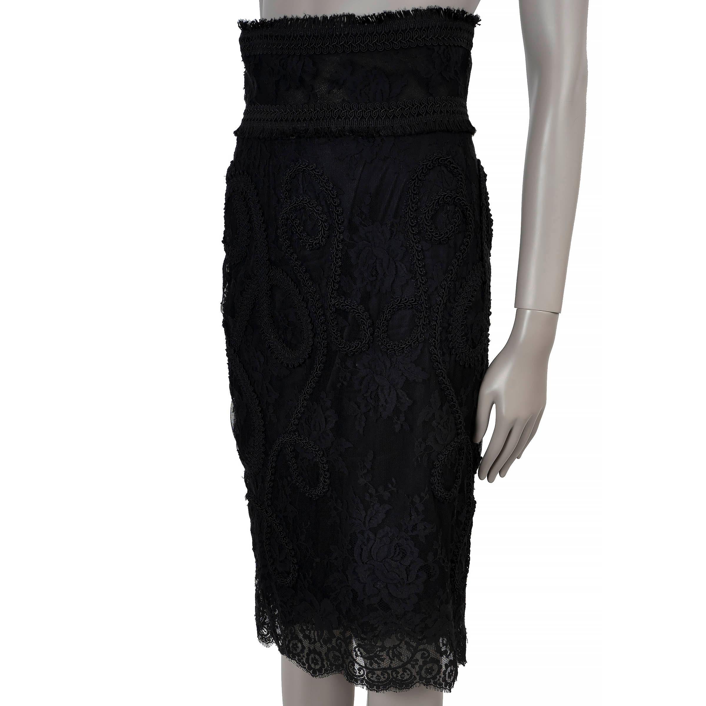 This 100% authentic Dolce & Gabbana high-waisted pencil skirt is a stunning combination of elegance and sophistication. Crafted with a floral lace upper layer featuring tonal black embroidery and a mesh underlayer, it ends just below the knee for a