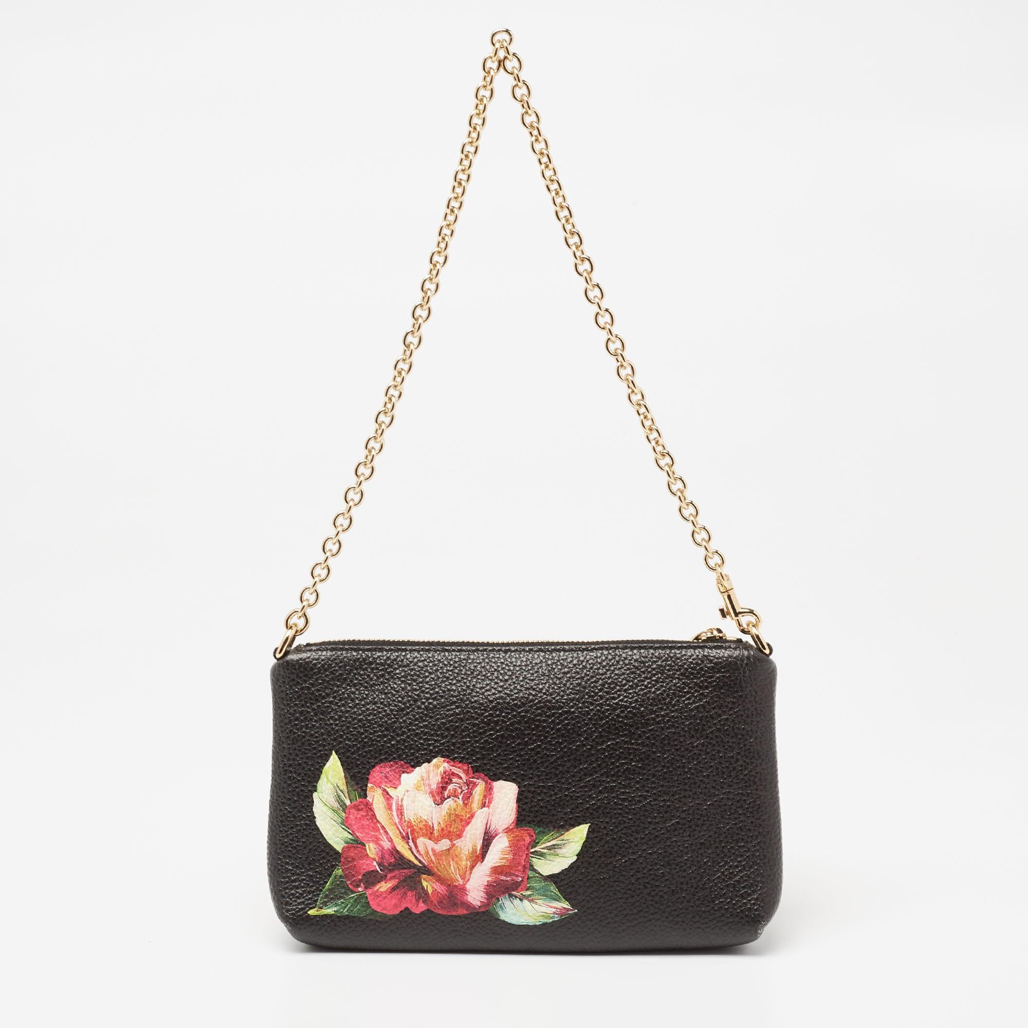 This Dolce & Gabbana clutch is just the right accessory to compliment your chic ensemble. It comes crafted in quality material featuring a roomy interior that can comfortably hold all your little essentials like lipstick, cards, and phone.