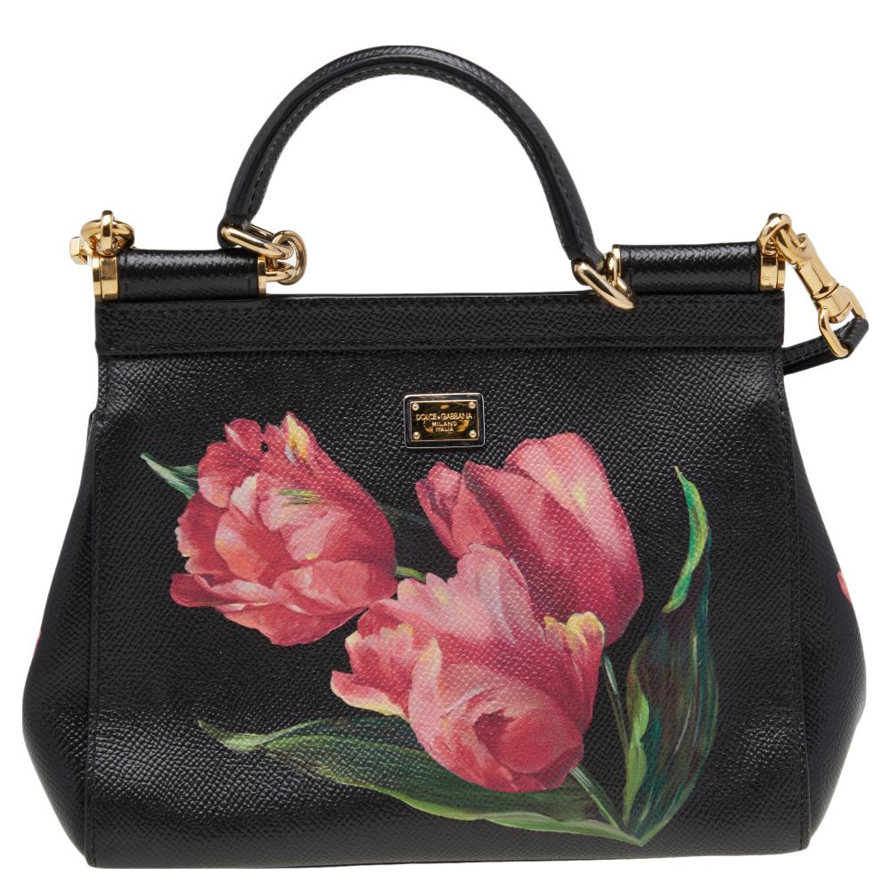 This gorgeous black Sicily bag from Dolce & Gabbana is a handbag coveted by women around the world. It has a well-structured design and a flap that opens to a compartment with canvas lining and enough space to fit your essentials. The bag is styled