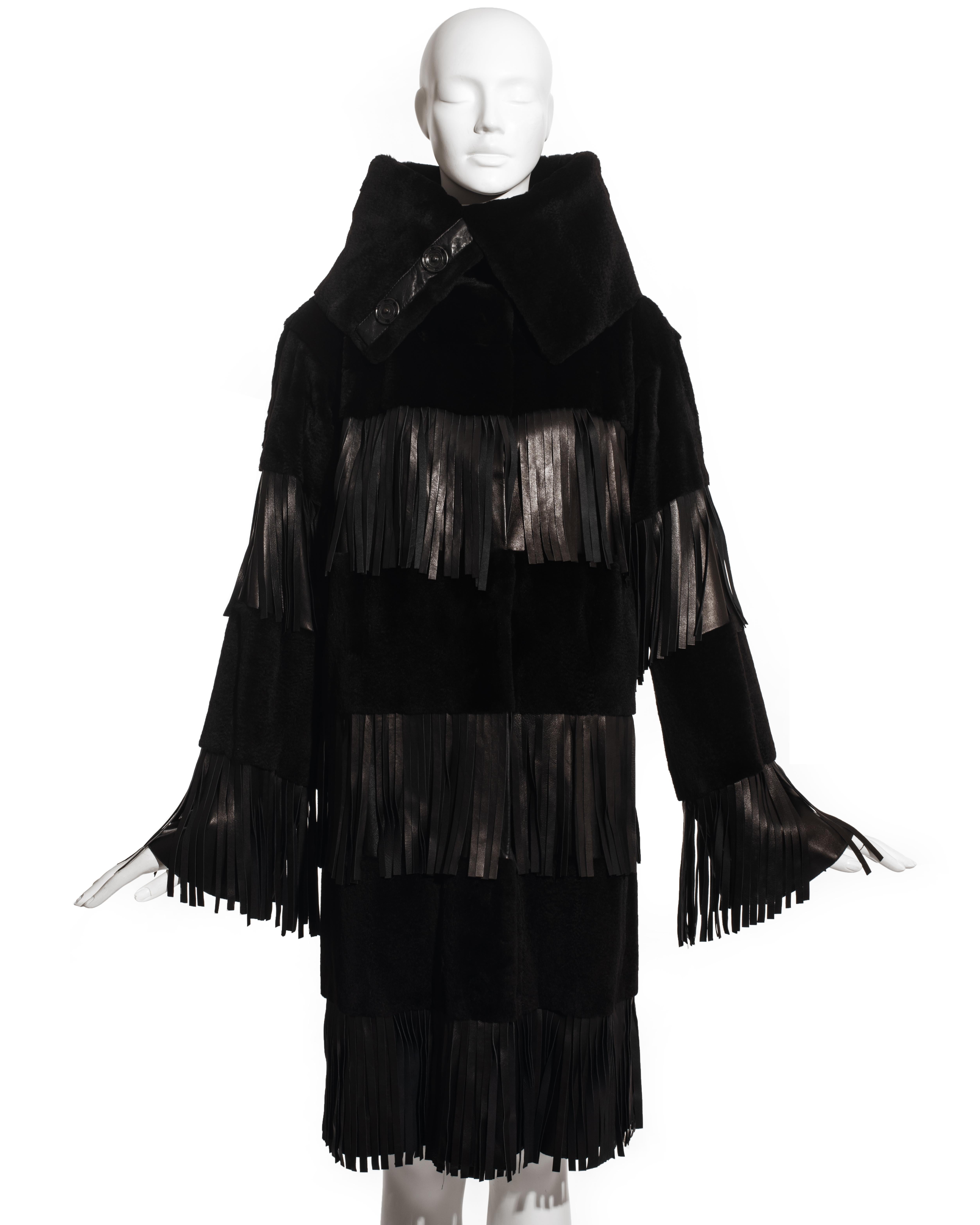 Dolce & Gabbana black weasel fur and lambskin leather coat with high turn-over collar, large snap fastenings and leather fringed trim. 

Fall-Winter 2003