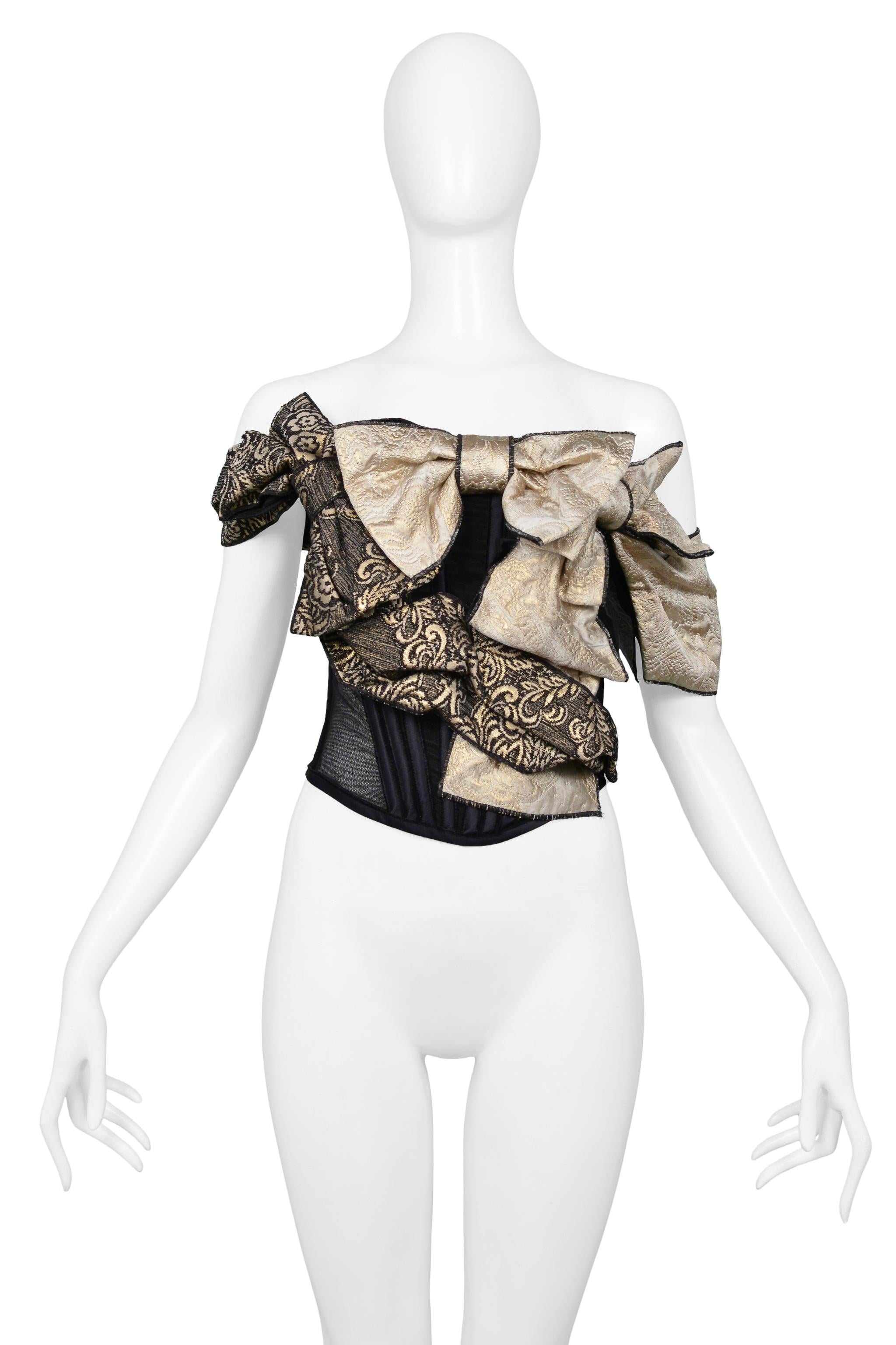 Resurrection Vintage is excited to offer a vintage Dolce & Gabbana D&G black corset top featuring large gold bows, deconstructed styling, boning and center back zipper.

Dolce & Gabbana
D&G
Size: 42
40% Acetate, 19% Cotton, 12% Acrylic, 8%