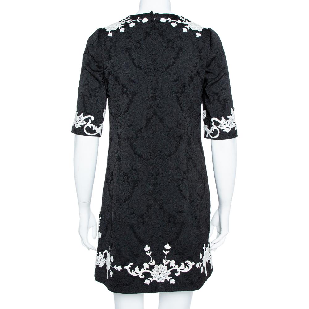 Elegant and easy to slip into, this Dolce & Gabbana shift dress is stunning. Crafted from quality fabric, it has a lovely black jacquard on its exterior and is adorned with contrast floral lace detailing, three-quarter sleeves and a round neckline.