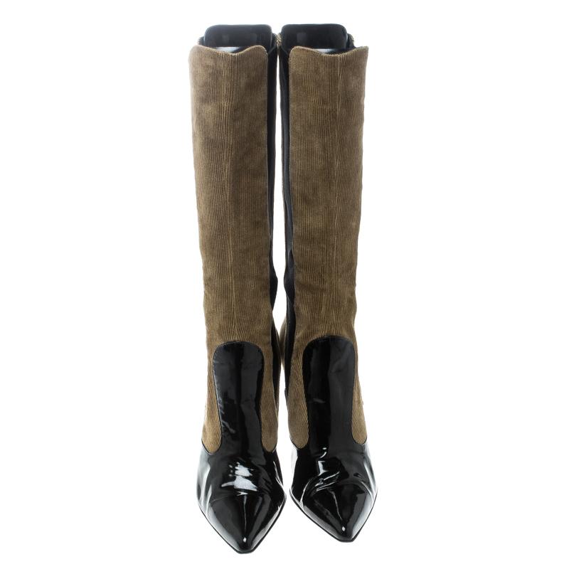These boots from Dolce & Gabbana were made to delight the tastes of all fashion-forward ladies. The pointed toe boots are crafted from black patent leather, corduroy in khaki green, and elastic fabric. The boots are finished with stiletto heels.

