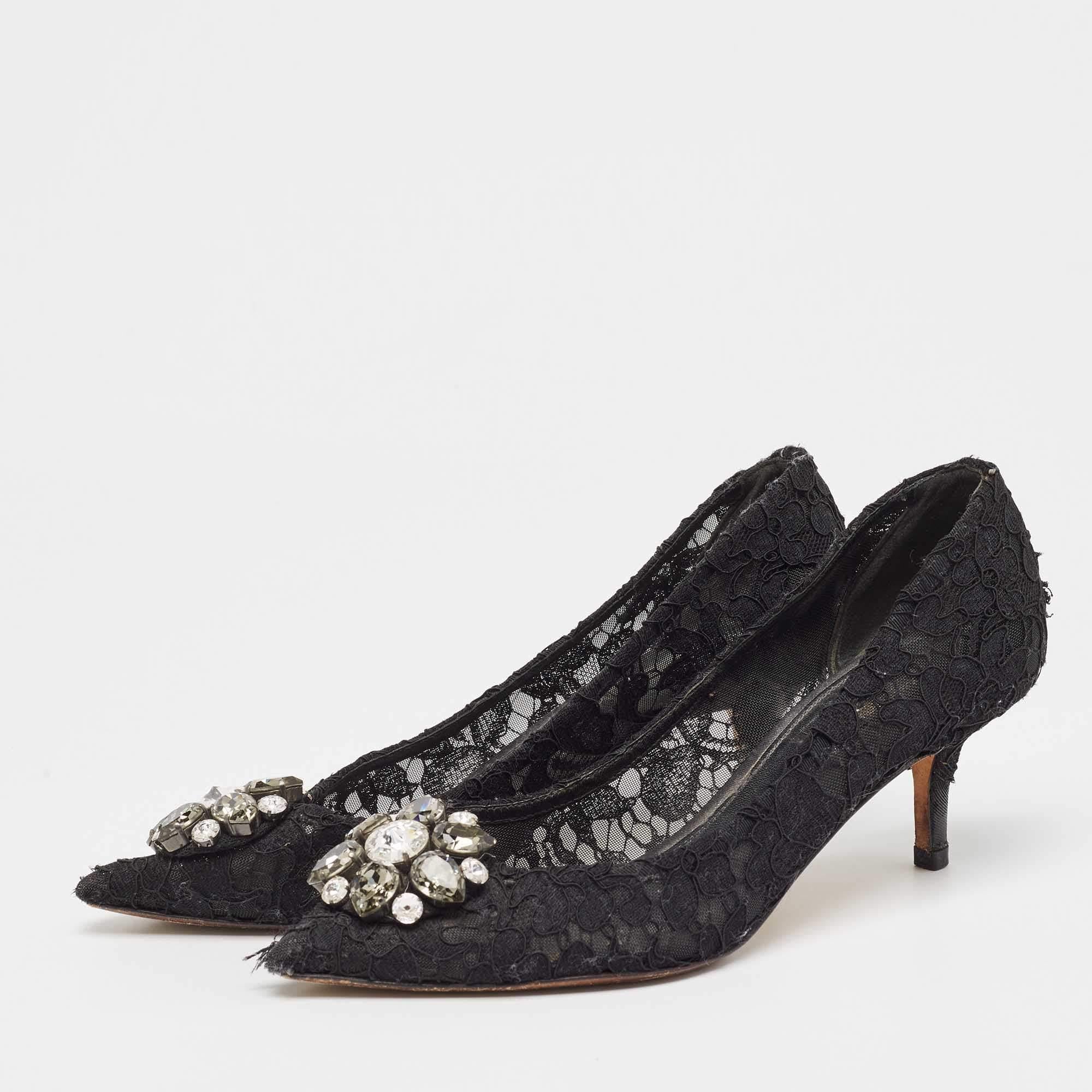 Este par de Dolce & Gabbana está intrincadamente diseñado con encaje y constituye una creación cautivadora. En un elegante tono negro, un precioso adorno de cristal se asienta sobre sus dedos y sus tacones de 7 cm añadirán gracia a cada paso.