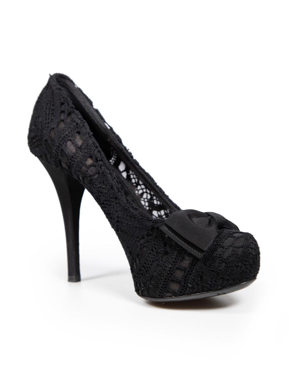 CONDITION is Very good. Minimal wear to heels is evident. General wear to soles on this used Dolce & Gabbana designer resale item. This item comes with original box and dust bag.
 
 Details
 Black
 Lace
 Heels
 Almond toe
 Front bow detail
 High