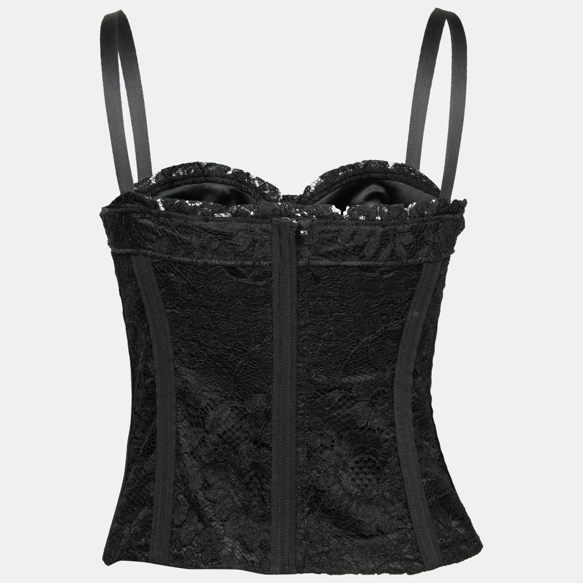 How cute is this corset top from the House of Dolce & Gabbana! Chic and charming, this corset top is the perfect summer accessory with its black hue and intricate lace trims. It can be secured with a zipper.

