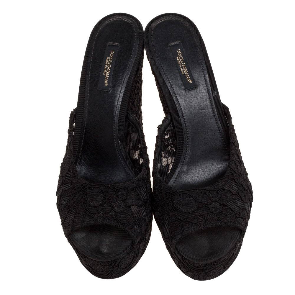 These sandals from Dolce & Gabbana are a perfect way to add glamour to your outfits. Crafted from lace and mesh, they come in a classic shade of black. They are styled with open toes, lace detailing on the platforms, and 12 cm wedge heels. They are