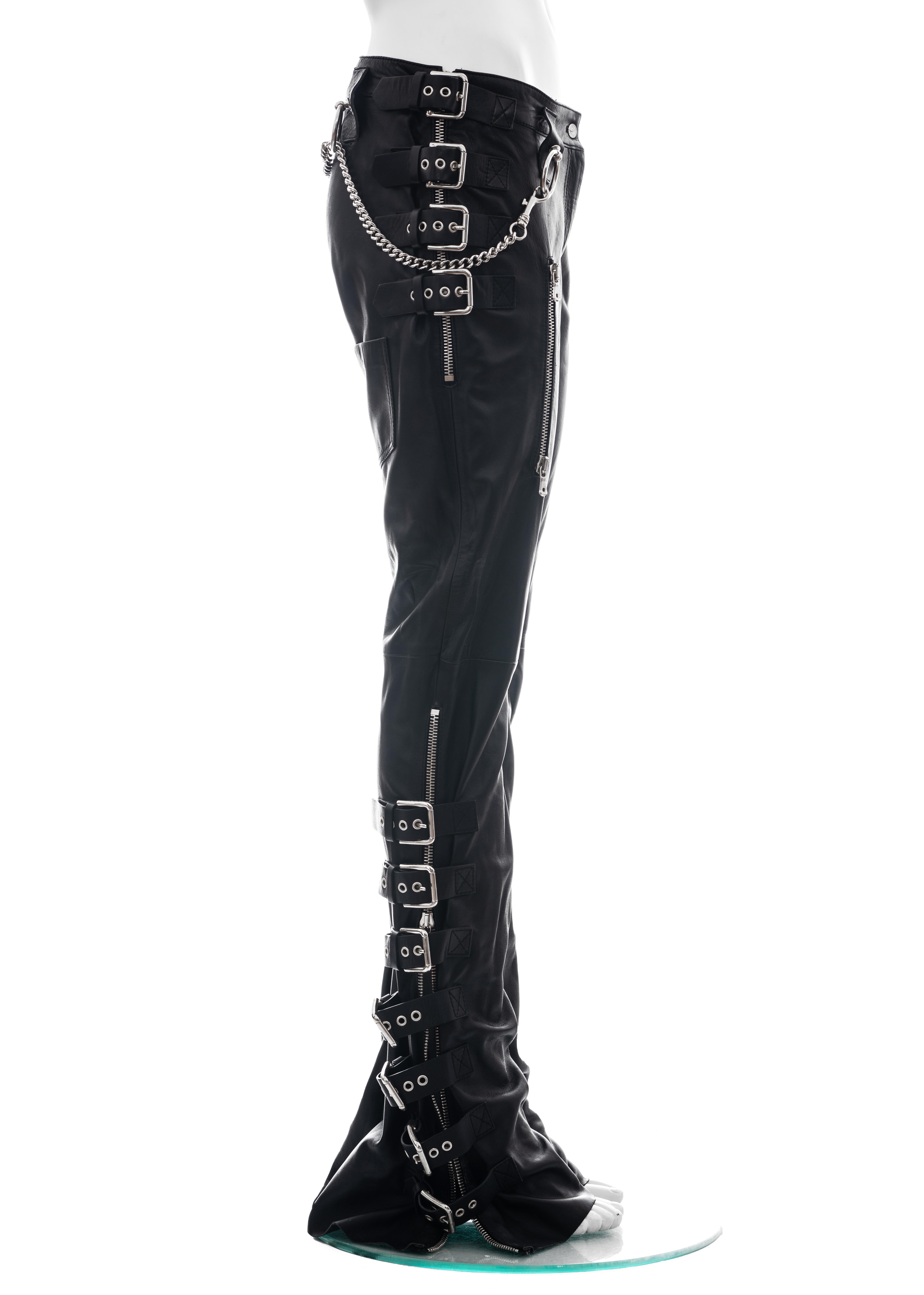 ▪ Dolce & Gabbana black lambskin leather pants 
▪ 100% Lambskin
▪ Twenty-two metal buckles 
▪ Zip-up sides and pockets 
▪ Four metal hoops 
▪ Metal chain around waist 
▪ IT 42 - FR 38 - UK 10 - US 6
▪ Spring-Summer 2003