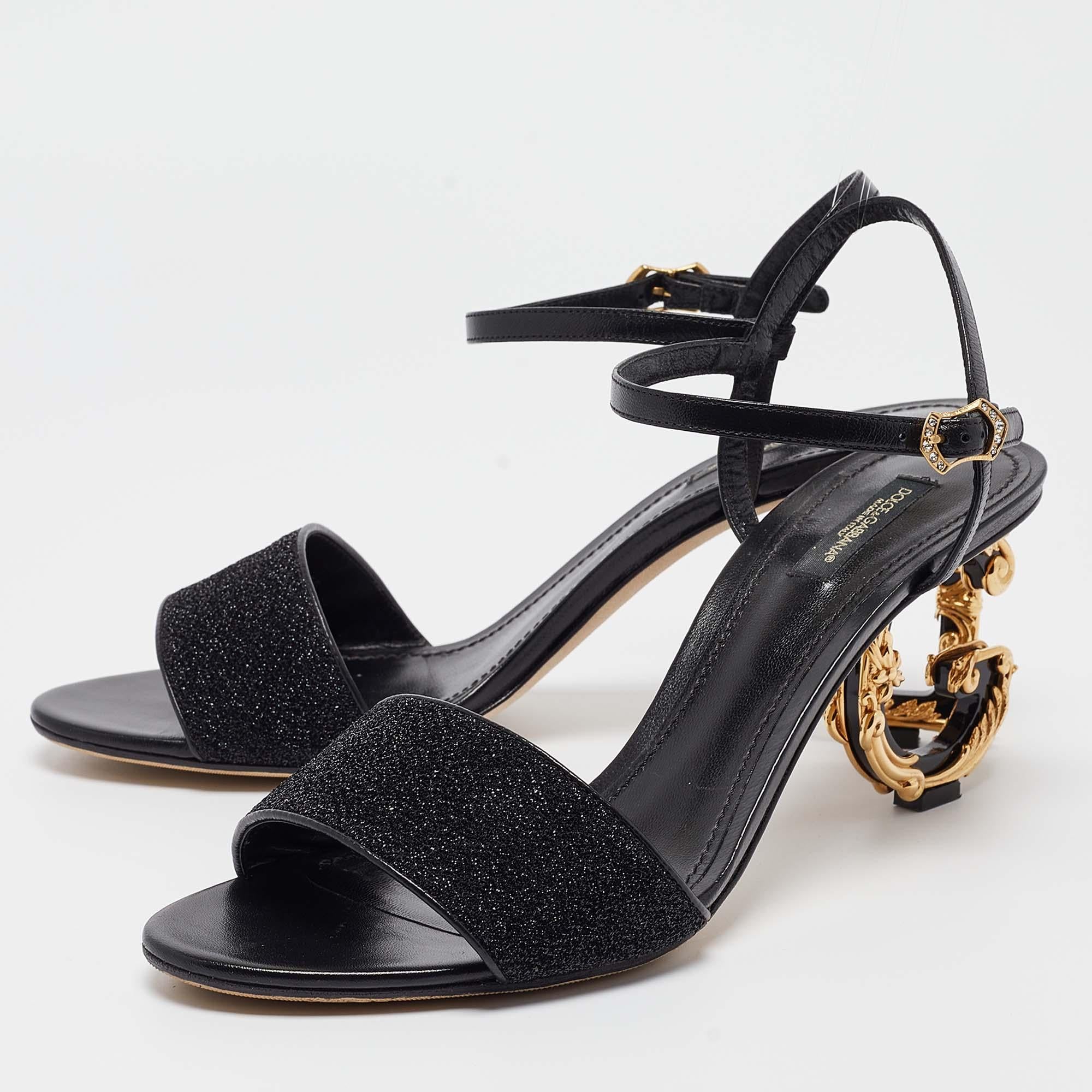 These gorgeous sandals from Dolce & Gabbana will add sparks of luxury to your wardrobe! The black sandals have leather straps, buckle closure, and high heels shaped in the iconic brand letters D and G.

Includes: Original Box, Info Booklet