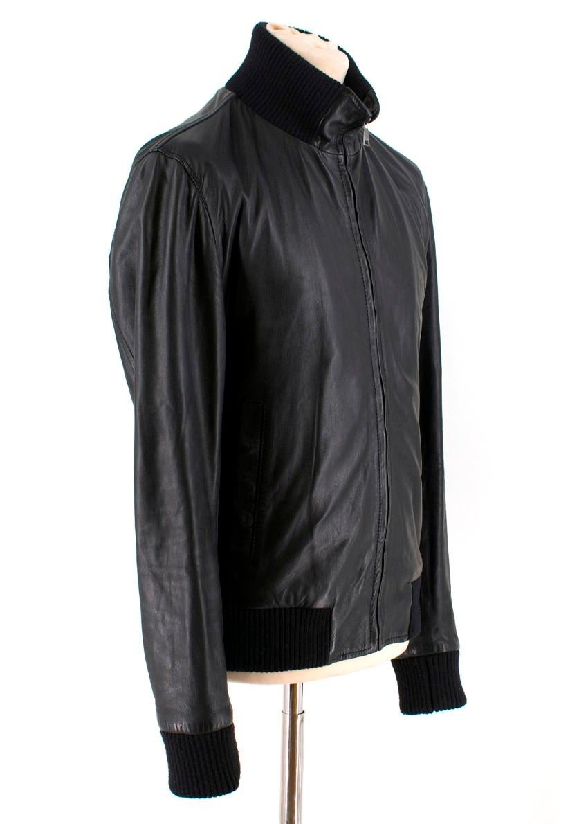 Dolce & Gabbana black leather bomber jacket

- Black, lamb leather 
- High neck, long sleeves 
- Black ribbed-knit neck, cuffs and hem 
- Slanted welt pockets 
- Two internal zip-fastening pockets 
- Centre-front zip fastening 
- Black polka-dot