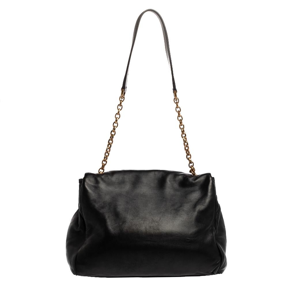 This lovely shoulder bag by Dolce & Gabbana is perfect for a host of occasions. Whether it is to run errands around town or have a fun outing with friends, this black-hued creation will get the job done. Crafted from leather, it has a front flap