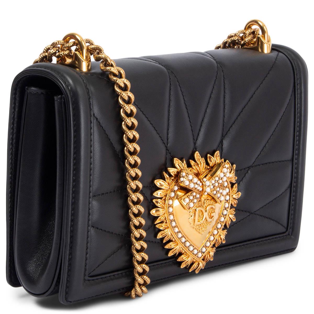 100% authentic Dolce & Gabbana Medium Devotion shoulder bag in black quilted nappa leather. Can be worn crossbody as well. It features the exclusive faux pearl bejewelled heart fastening in metal with vintage gold finish and the shoulder strap