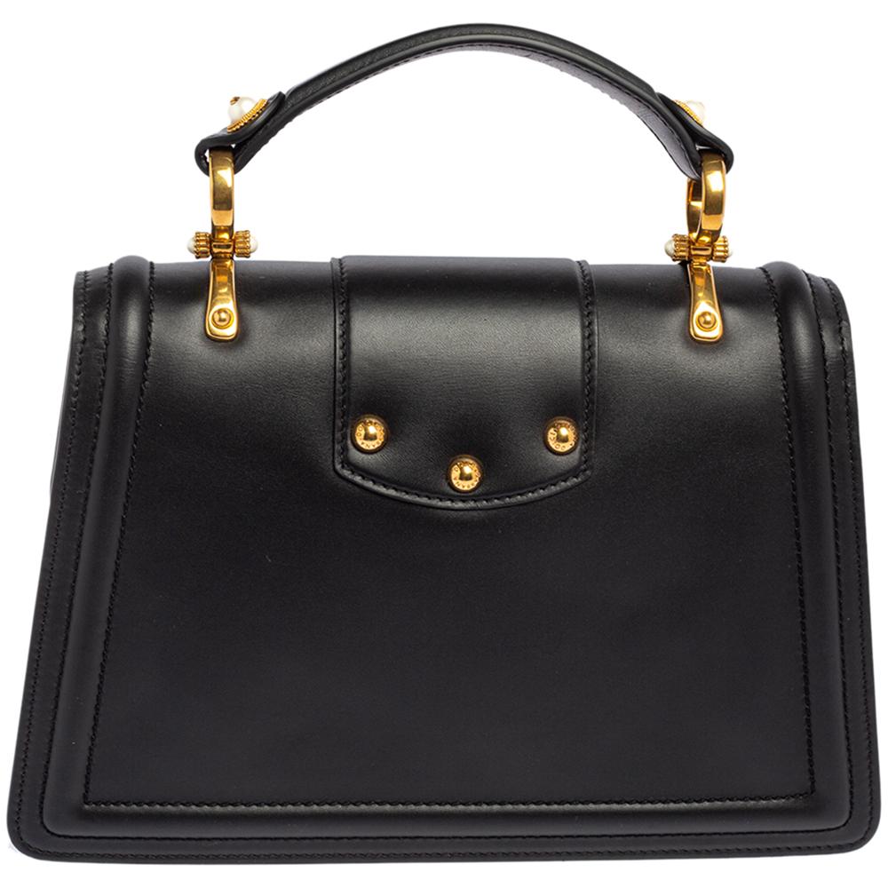 The DG Amore bag by the House of Dolce & Gabbana is the epitome of poise and luxury. The black leather exterior exhibits an ornate DG logo on the front that delivers a very exquisite look. In addition, the bag comprises of a top handle and comes