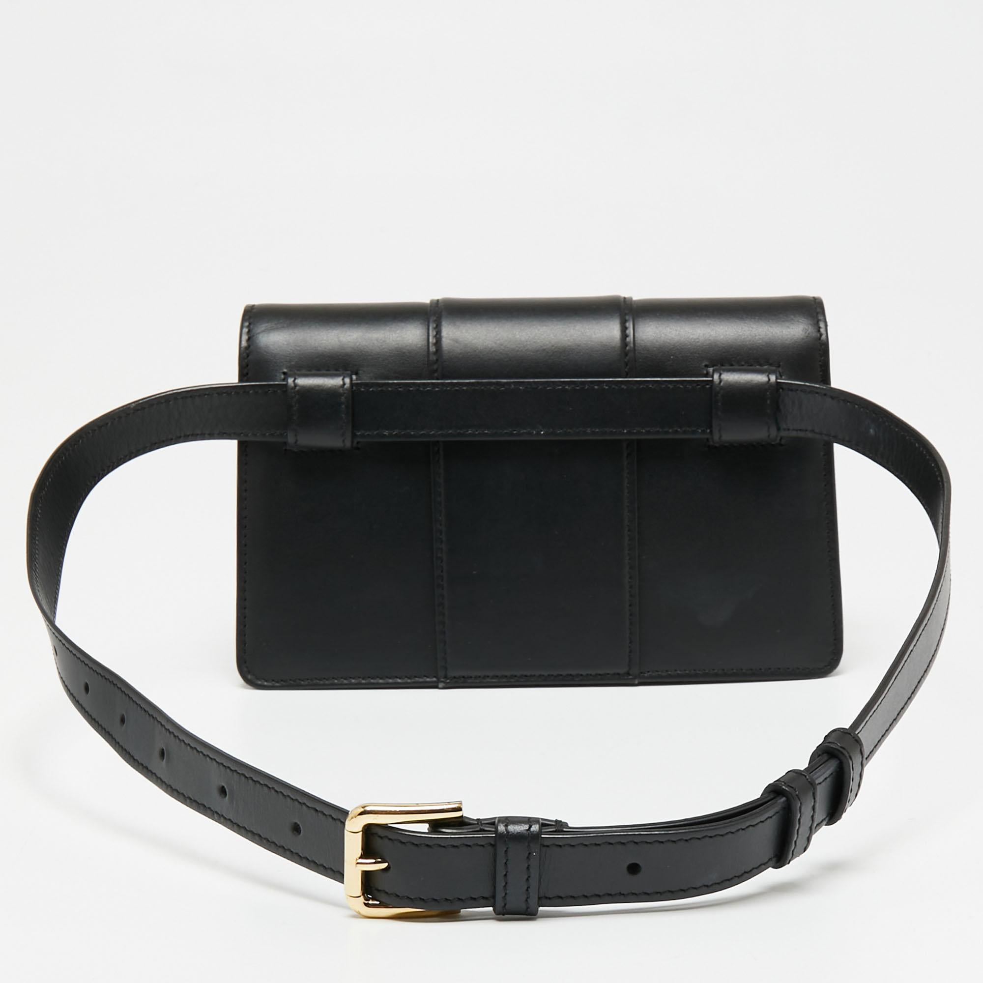 For days when you need just essentials, carry this uber-chic Dolce & Gabbana belt bag. It has been expertly crafted from durable leather in a structured silhouette. It comes with a DG metal detailing on the front flap and has a well-sized