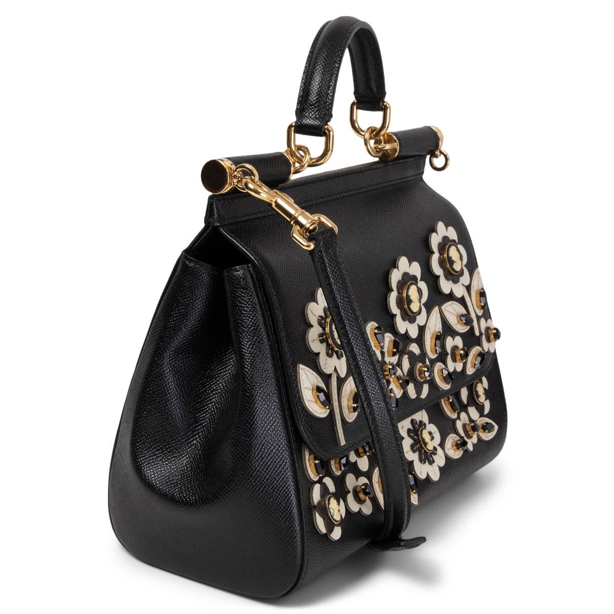 100% authentic Dolce & Gabbana Sicily Medium bag embellished with off-white flowers and crystals featuring light gold-tone hardware. The design has a structured shape and is crafted from grained black leather. The bag features a top handle and a