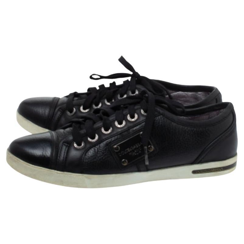 Sturdy and stylish, these low-top sneakers by Dolce & Gabbana are perfect with casuals. They have been crafted from quality leather in a classic shade of black. They are styled with lace-ups, logo detailing on the sides and rubber soles.