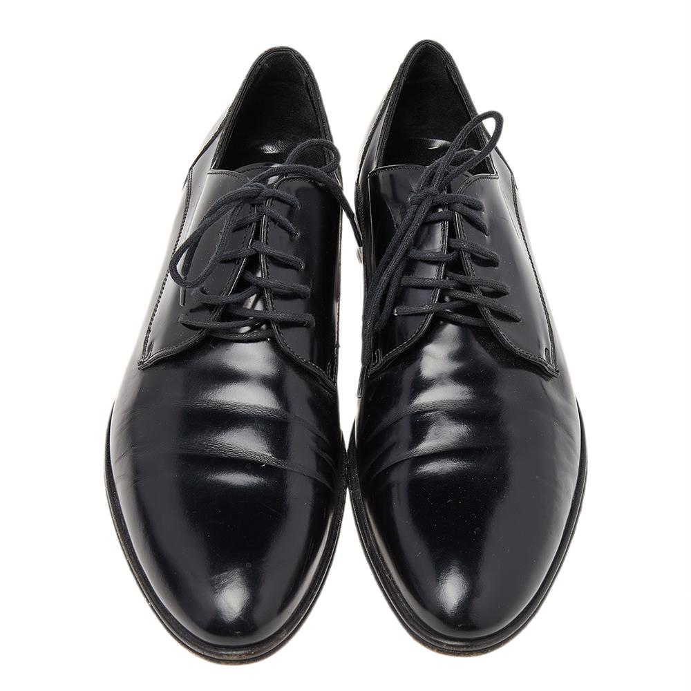 Stylish and smart, this pair of derbies from Dolce & Gabbana is a must-have. Crafted from polished black leather, they are styled with a leather-lined interior and lace-ups at the vamp. This pair is one creation that will give your formal looks an