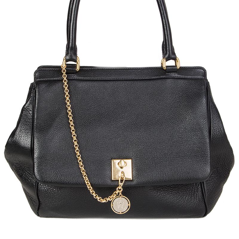 Dolce & Gabbana large shoulder bag in black grained leather. Flap pocket with lock and crown-coin. Closes with a magnetic-snap on top. Lined in leopard fabric with two open pockets against the front and a zipper pocket against the back. Has been