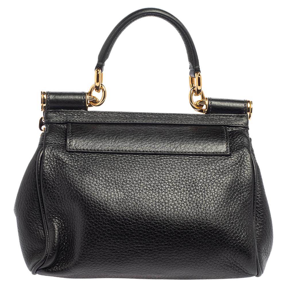 This luxe Mini Miss Sicily Bag by Dolce & Gabbana is perfect to wear on both daytime and evening occasions. Crafted from smooth leather, it is accented with a polished gold Dolce & Gabbana plate, a shoulder strap, and a single handle. The interior