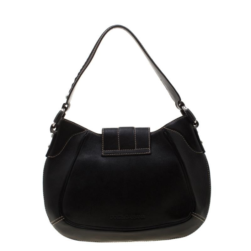 This sleek leather bag, with a fabric interior and silver-tone hardware, is luxurious enough to elevate your everyday style. The black bag is by Dolce & Gabbana and it is designed to be durable and handy.

