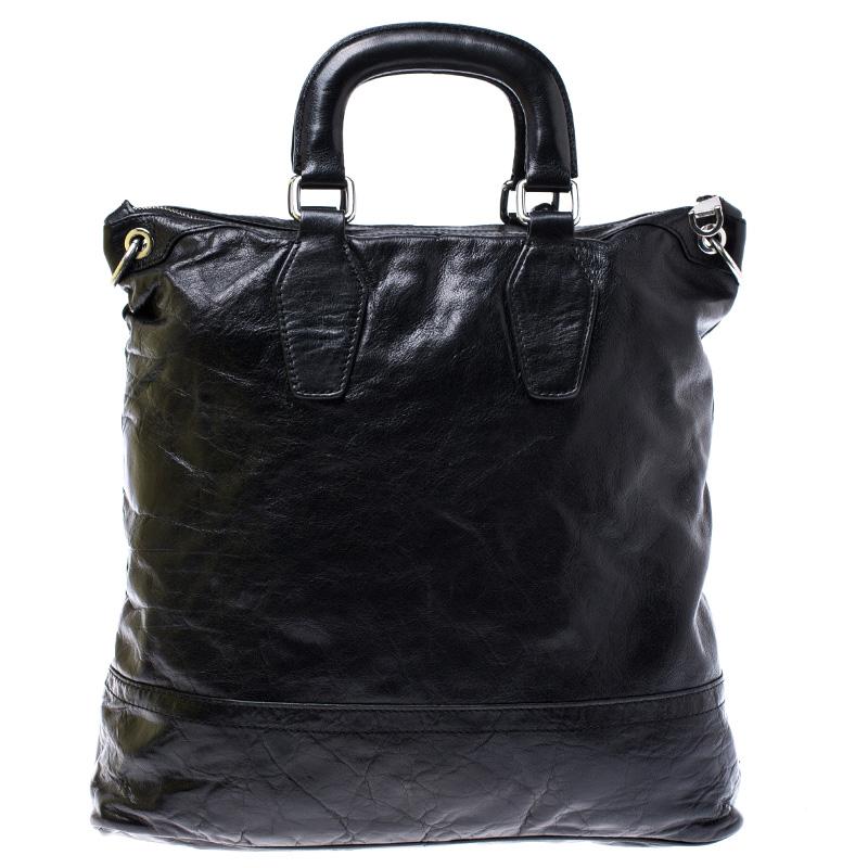 Crafted with durable leather, this tote makes an ideal companion for all your needs. With an expertly lined fabric interior, this bag can accommodate all your essentials. Add a signature touch to your collection of accessories with this Dolce &
