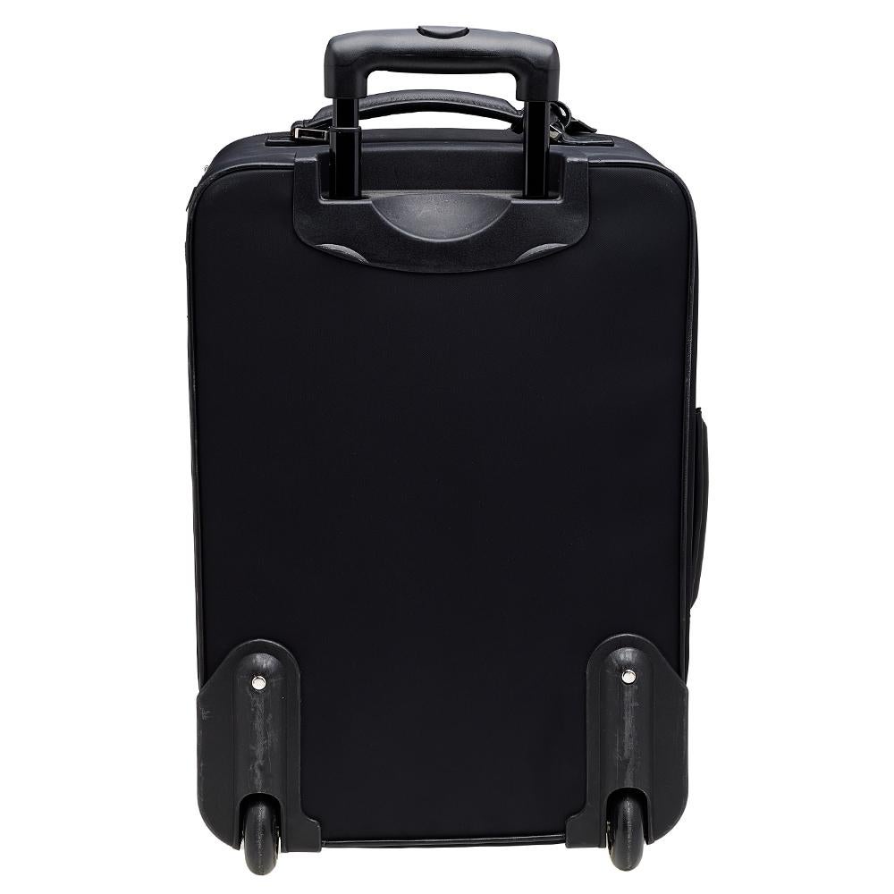Travel in style with this Dolce & Gabbana trolley luggage case. This bag in black nylon has a telescopic handle, a top handle, two wheels, and a spacious interior that can carry all your essentials. Offering a great look and durability, this luggage