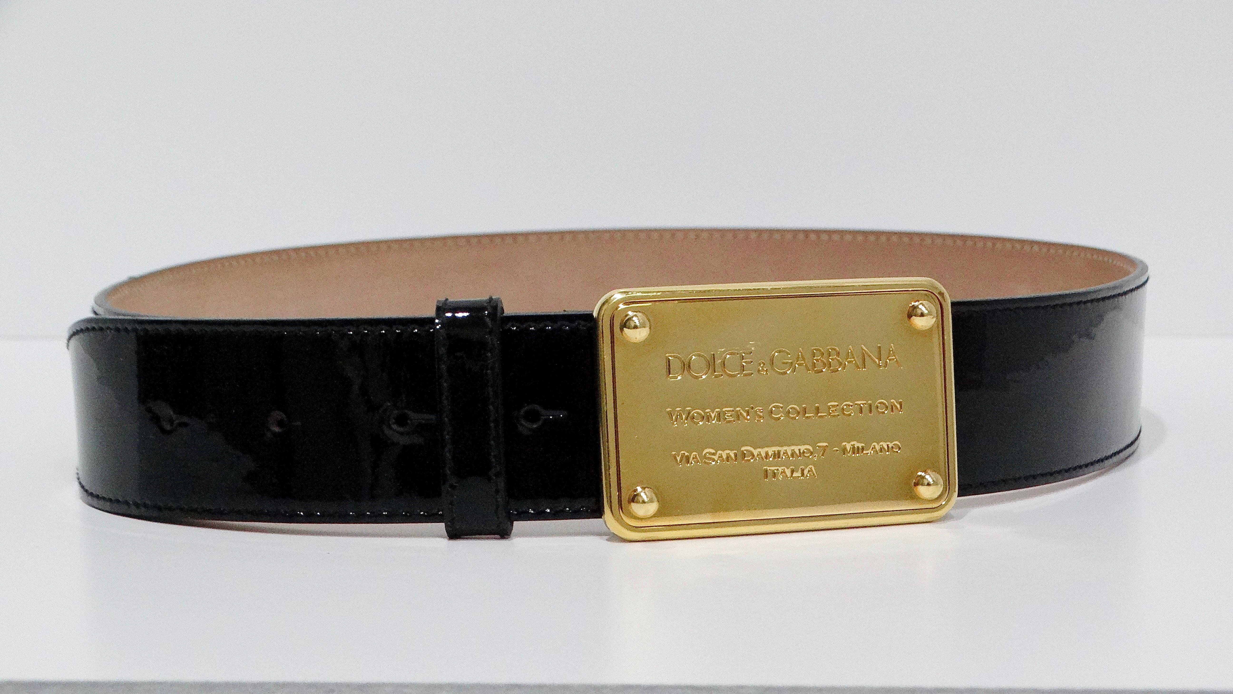 The Dolce & Gabbana black patent leather belt is a sophisticated accessory that exudes elegance and luxury. Featuring a buckle engraved with 