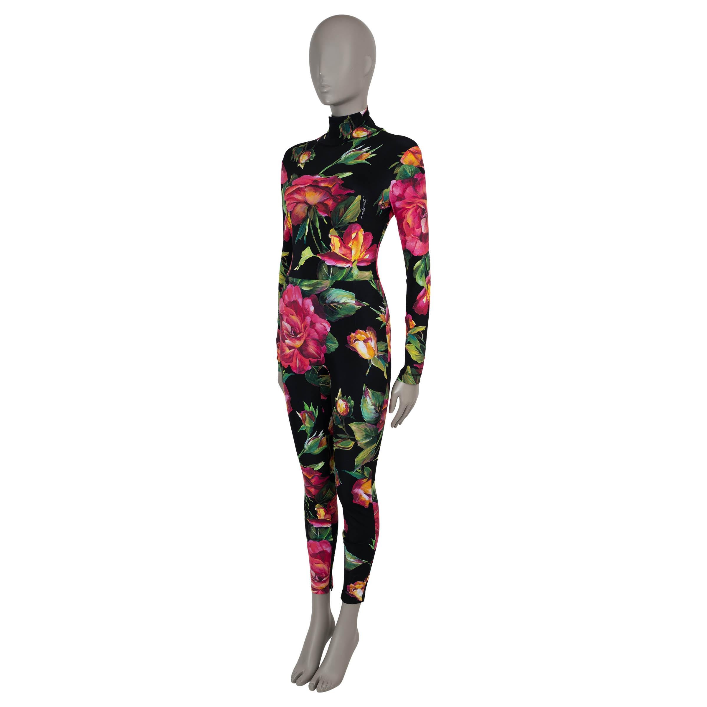 This 100% authentic Dolce & Gabbana catsuit in black stretch jersey polyamide (71%) and elastane (29%) is a bold and sophisticated statement piece. Adorned with a vibrant pink and green rose print, it features a bodycon silhouette that elegantly