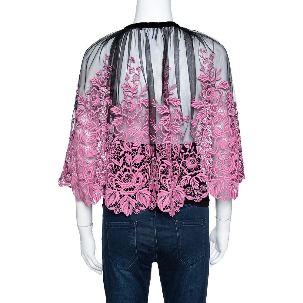 Dolce & Gabbana delights us with this lovely black and pink cape top that has been tailored from quality materials and styled with Guipure lace, sheer panels and tie detailing at the front.


