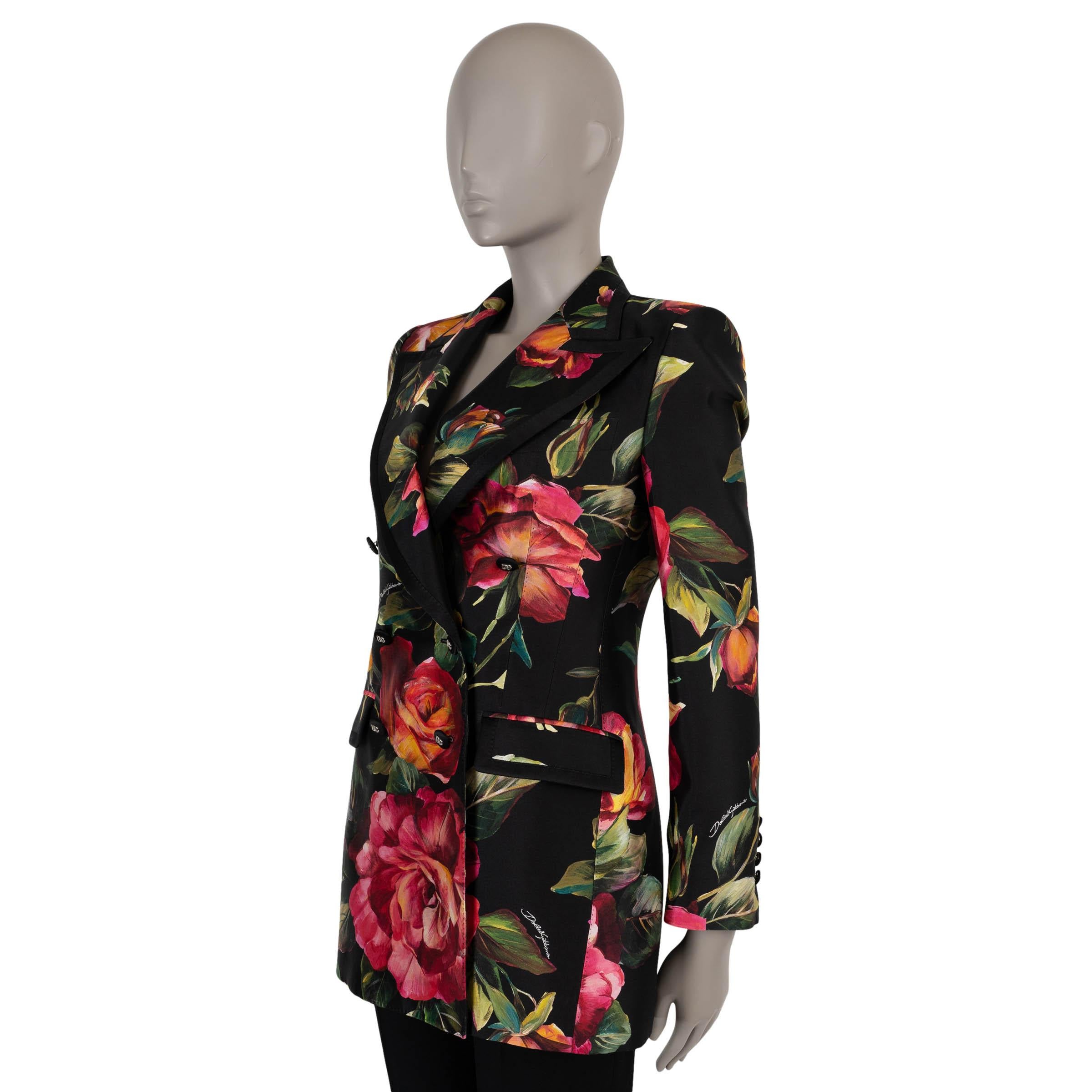 This 100% authentic Dolce & Gabbana blazer in black silk (with 2% elastane) is a statement piece, adorned with a romantic pink and green rose print. Featuring a fitted silhouette, large peak lapels, and satin trims, it exudes timeless