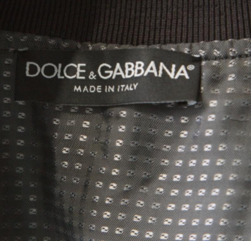 Step out in style in this fabulous bomber jacket from Dolce & Gabbana! The black creation features an embroidered polka dot design and comes with a front zip fastening and long sleeves. It flaunts dual zip pockets on the front and is sure to lend