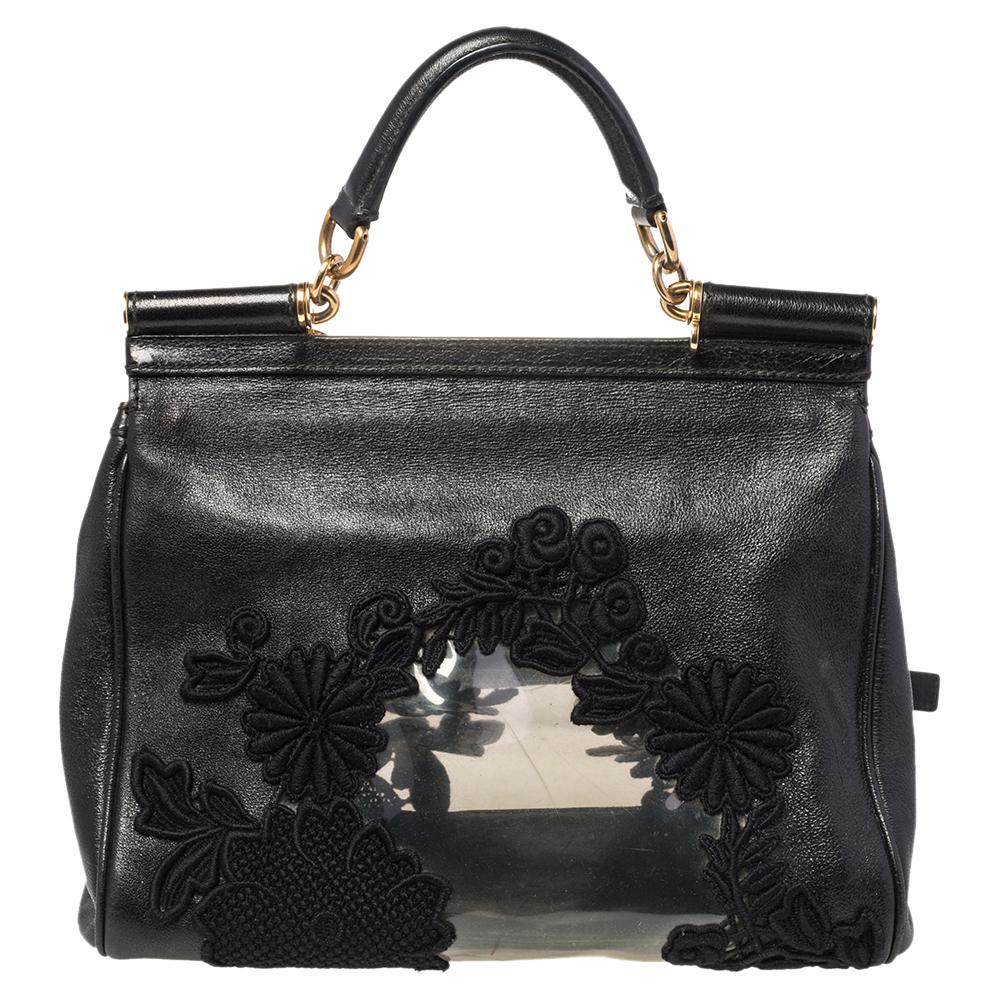 This Miss Sicily bag from Dolce & Gabbana is made from PVC, lace, and leather. It has a spacious compartment, gold-tone hardware, a top handle, and the brand plaque at the front. Complete all your chic ensembles with this luxurious bag.

Includes: