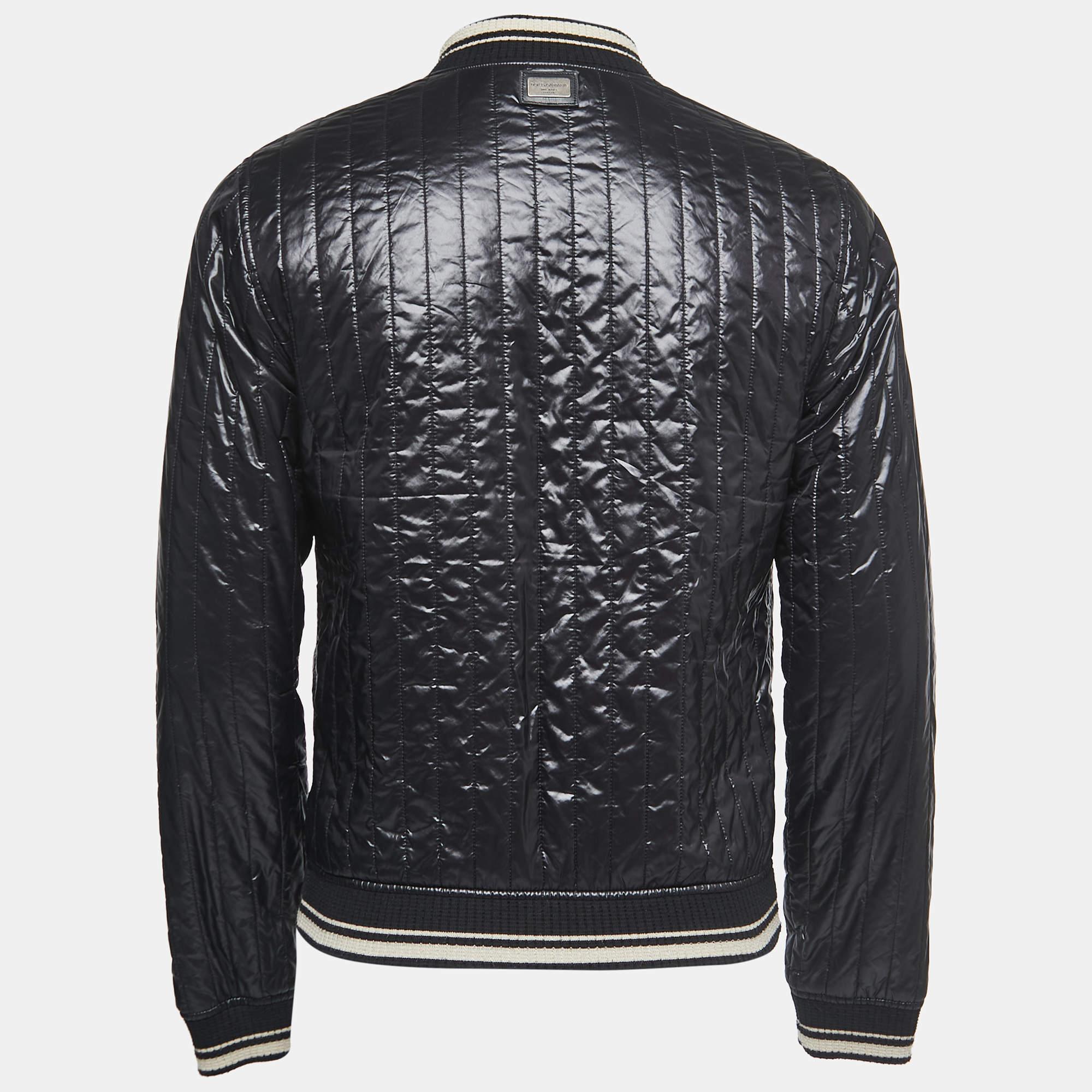 The Dolce & Gabbana Black Bomber Jacket exudes sleek and contemporary style. Crafted with precision, it features a classic bomber silhouette, a black color palette, and high-quality materials. With its versatile design, this jacket effortlessly