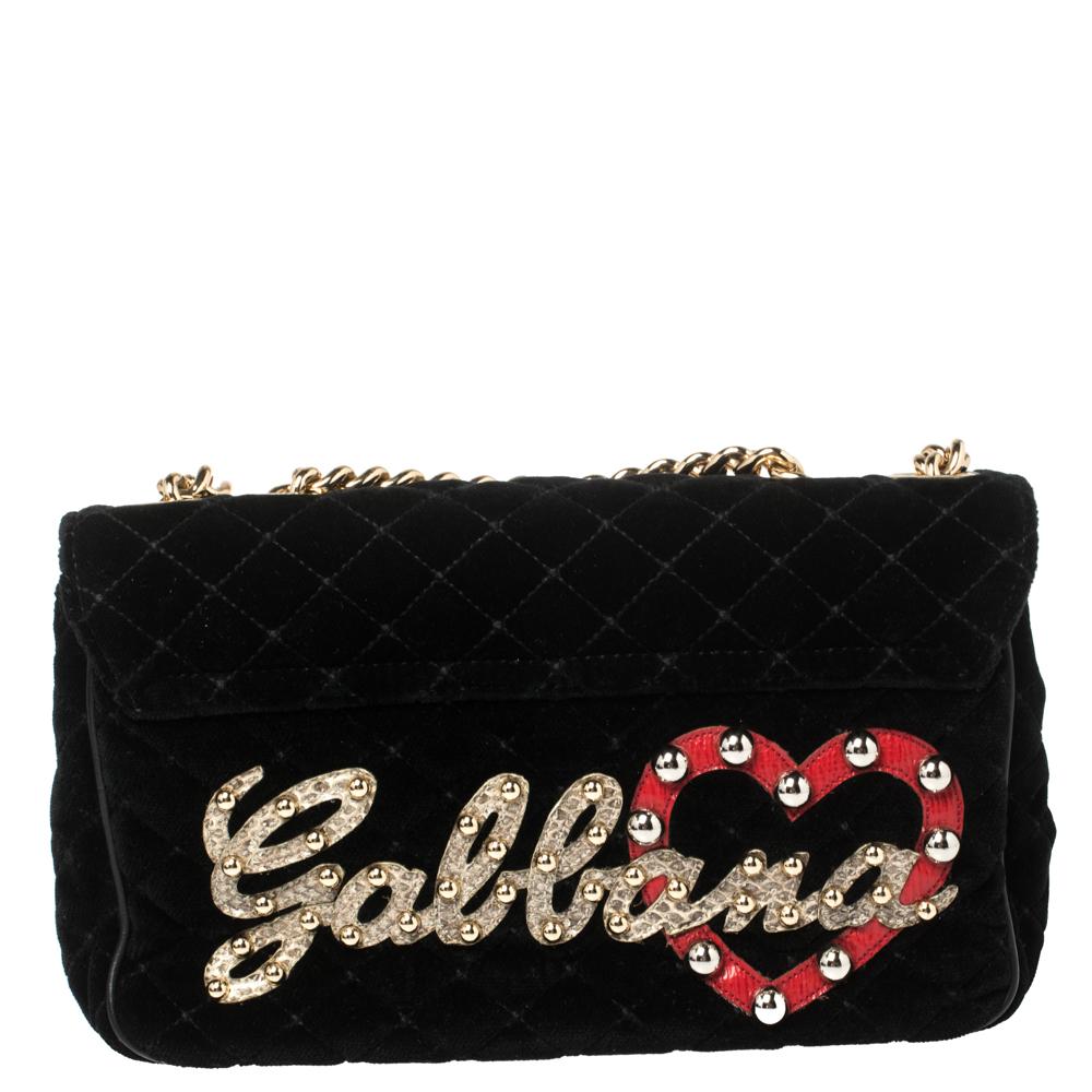 Dolce & Gabbana's Lucia shoulder bag has been expertly designed from quilted velvet and detailed with embellishments that lend it a chic & trendy look. It comes with a flap style secured with gold-tone metallic closure and is sized perfectly to hold