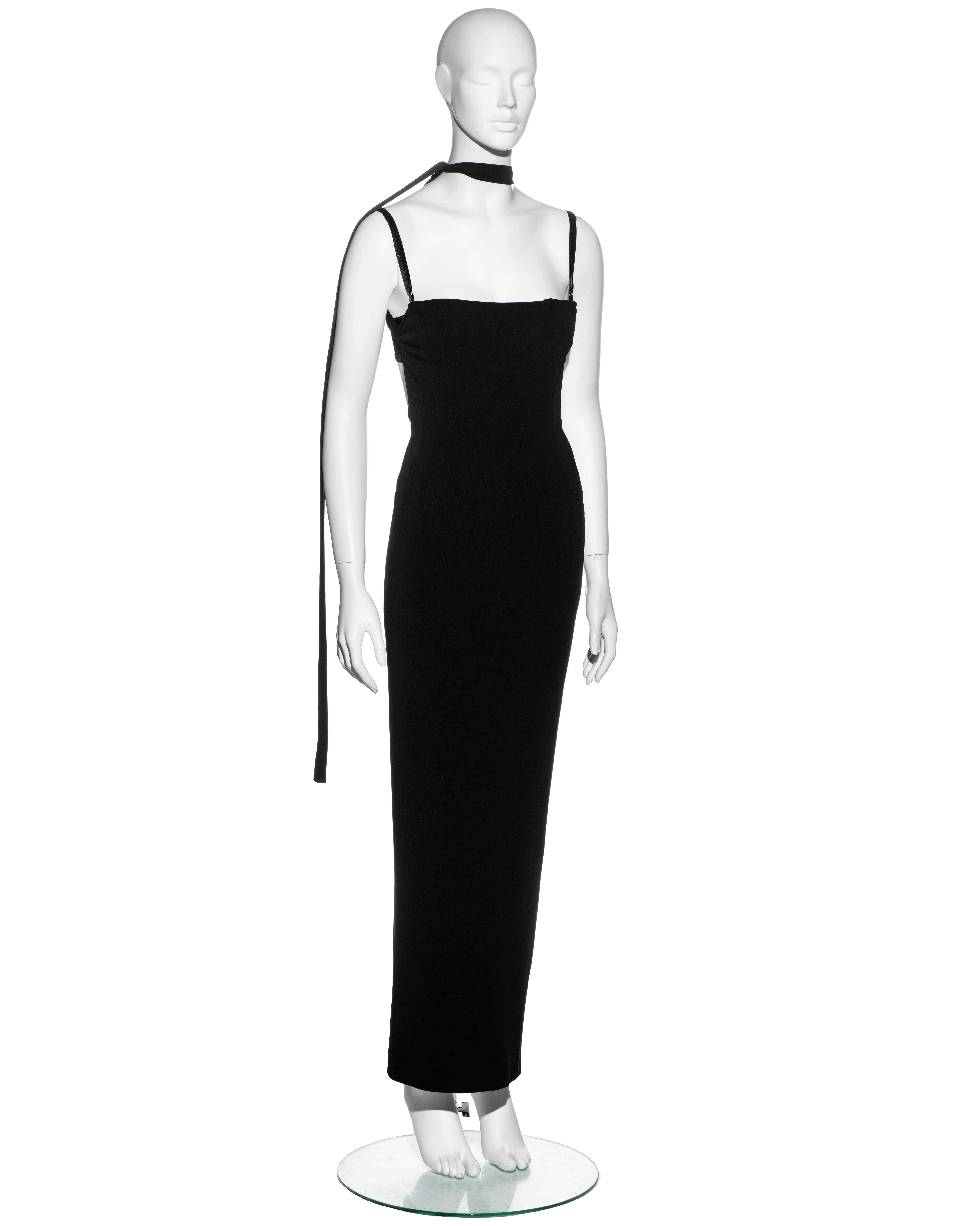 ▪ Dolce & Gabbana black maxi dress 
▪ 75% Rayon, 17% Nylon, 8% Spandex 
▪ Built-in bra 
▪ Open back 
▪ Two criss-cross bandage straps at back fastening at the neck 
▪ Size Small
▪ Spring-Summer 2001