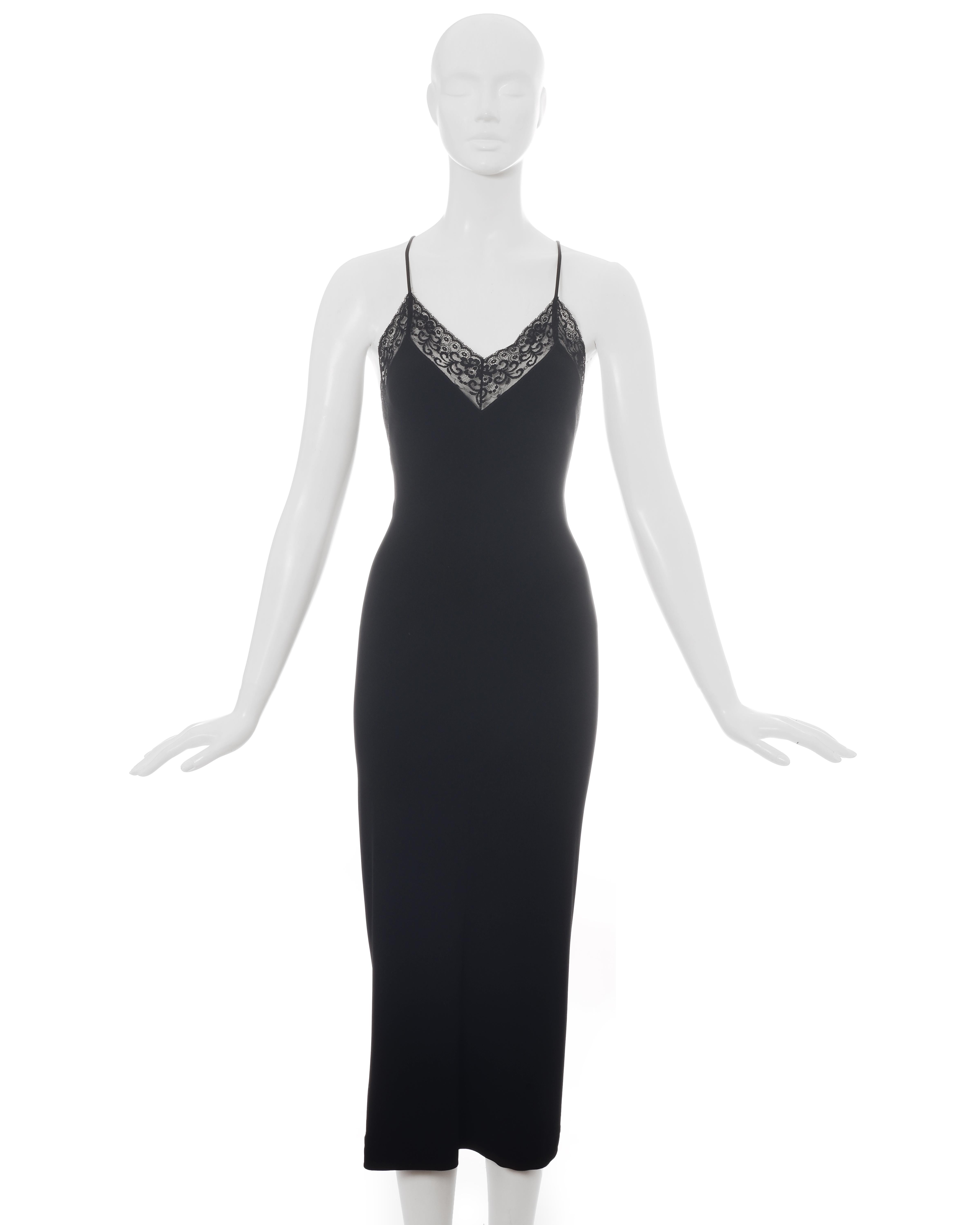 Dolce & Gabbana black rayon figure hugging mid-length low back evening dress with lace trim and criss-cross spaghetti straps.

c. 1996-1999