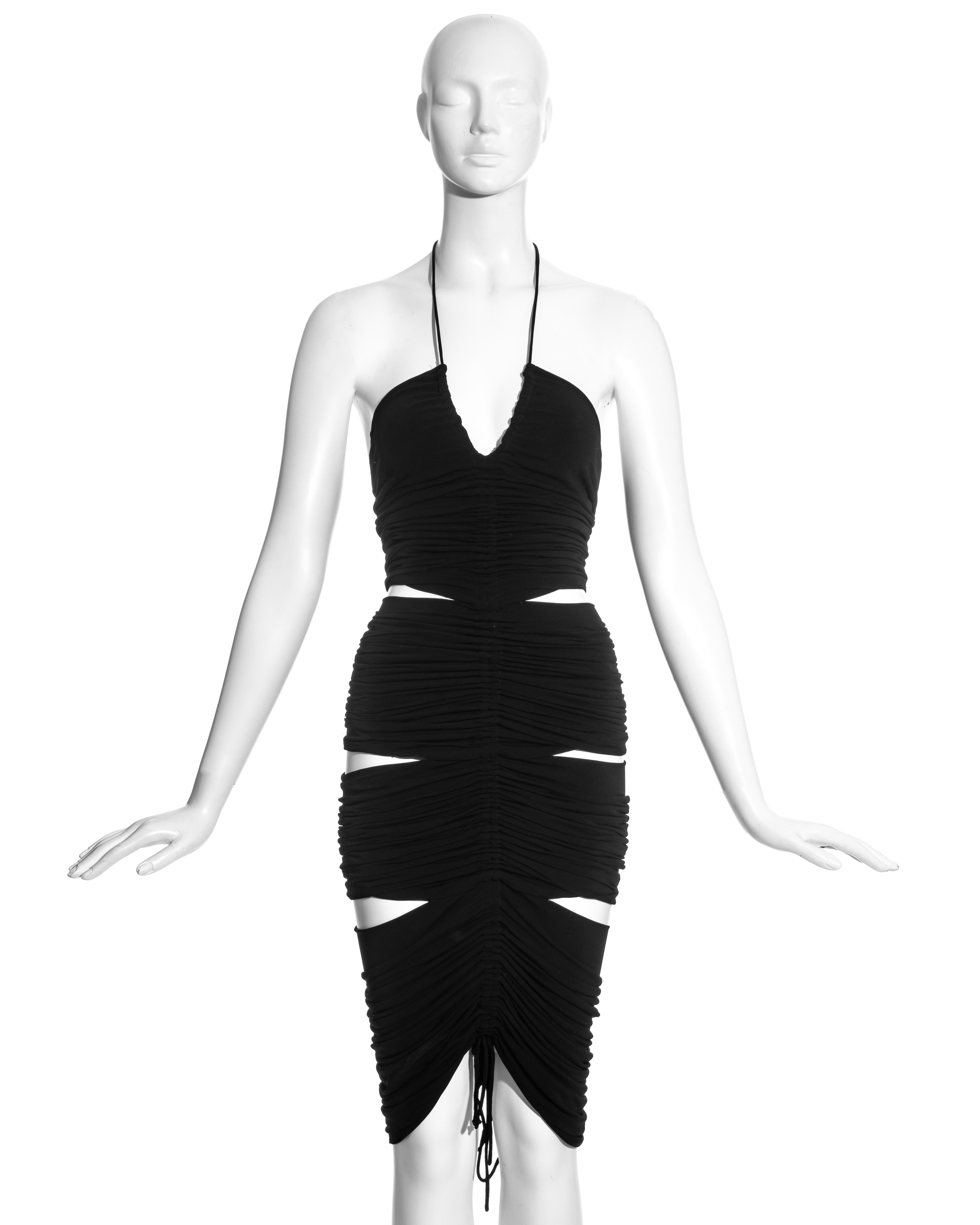 Dolce & Gabbana black rayon figure-hugging halter neck dress with two drawstring ruched seams; front and back, and six skin baring cut-outs. 

Spring-Summer 2003