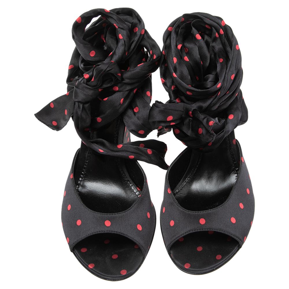 These sandals from Dolce & Gabbana are beautiful in every way. They have been created intricately using black-red fabric on the exterior and exhibit a beautiful ankle wrap feature. They come with open-toes and stunning wedge heels. Your feet will