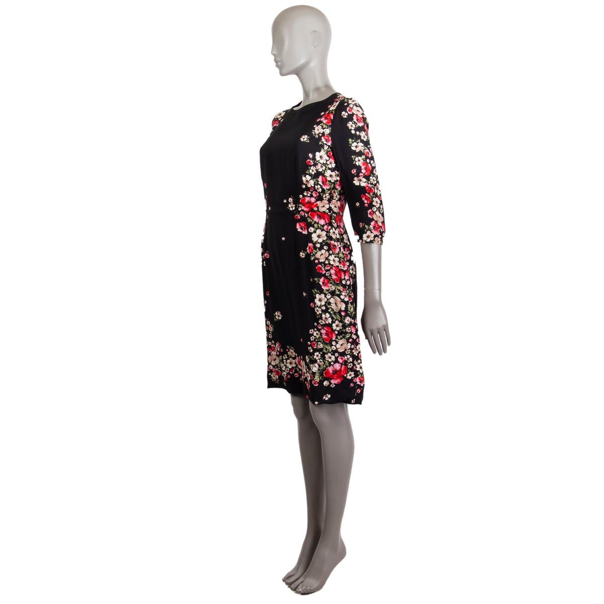 Dolce & Gabbana flower printed 3/4 sleeve sheath dress in black, red, taupe, nude and green viscose blend (missing tag). Lined in black silk (missing tag). Opens with a zipper on the back. Has been worn and is in excellent condition.

Tag Size