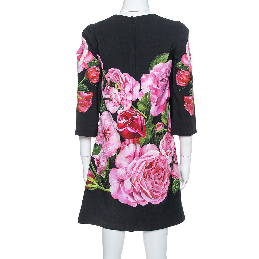 This shift dress is from Dolce & Gabbana exemplifies the label's quintessential spirit of today's woman. This splendid creation features an interesting rose print all over. It is complete with a round neckline, three-quarter sleeves, a zip closure