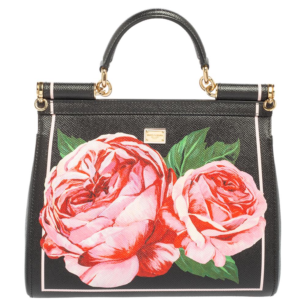 Meticulously crafted into an eye-catchy shape, this Miss Sicily bag from the House of Dolce & Gabbana exudes just the right amount of charm and elegance! It is made from black leather, augmented with a rose print. The bag's silhouette is accentuated
