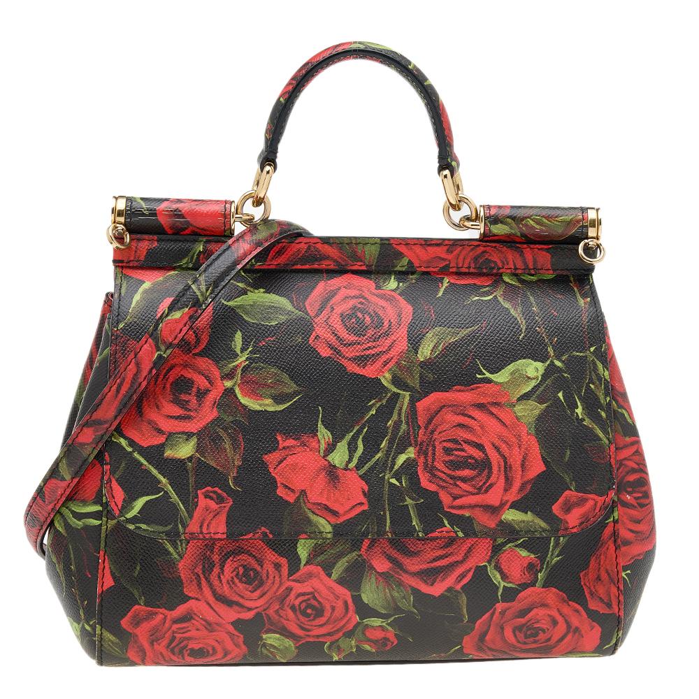 Meticulously crafted into a lovely feminine shape, this Miss Sicily bag from Dolce & Gabbana exudes just the right amount of charm and elegance! It is made from black leather and is adorned with a mesmerizing rose print. The bag is accentuated with